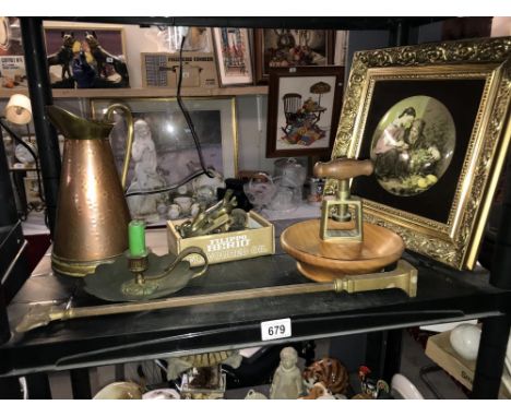 A shelf of old brassware including old chamber candlestick etc.