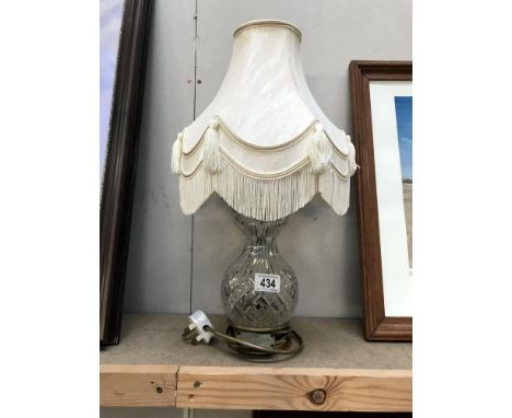 A cut glass table lamp with shade