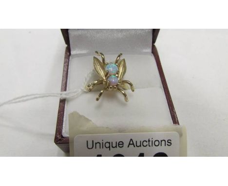 A 2 stone yellow gold ring shaped as a fly and set 2 opals, size N half.