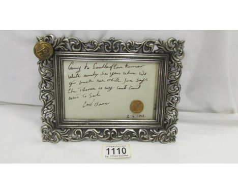 A 1912 sovereign placed on a letter relating to the Titanic in a later frame with officers button attached to frame. ****Cond