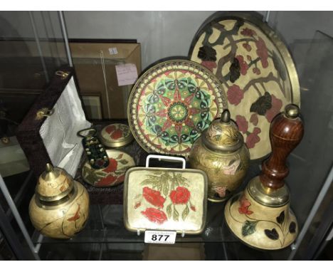 A shelf of enamelled brass