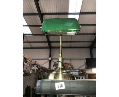 A desk lamp with green shade