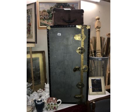 A large trunk and a suitcase