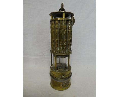 An unusual brass Miner's lamp by Wolf Safety Lamp Co of America with cylindrical lens and swing handle