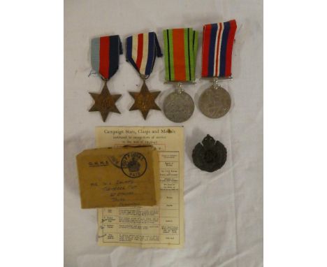 A 1939/45 star, France &amp; Germany star, Defence medal and War medal together with box of issue and Army Council slip named