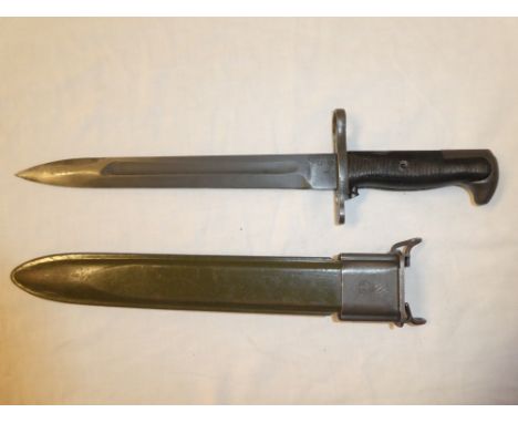 A United States Army bayonet with single edged blade in composition and steel scabbard