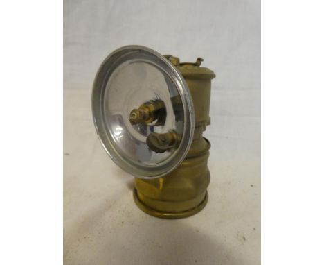A small brass Cornish Premier Acetlyne Miner's lamp with circular reflector