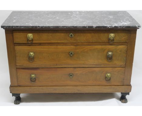 A BIEDERMEIER MAHOGANY THREE DRAWER COMMODE with grey marble top, with brass lion handles on associated hairy paw feet, 87cm 