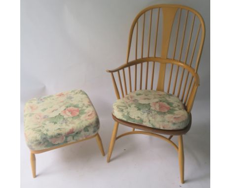 AN ERCOL CHAIRMAKERS CHAIR WITH SEATPAD 108cm high and a footstool with matching cushion 38cm high x 52cm wide x 52cm deep (2