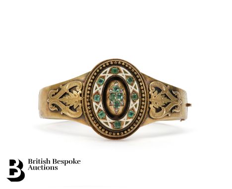 A Continental Neo-Etruscan 14/15ct enamel, diamond and emerald bangle. The bangle set with an oval motif set with four emeral