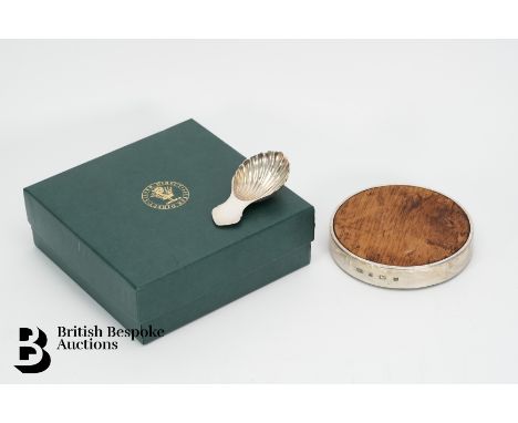 Silver rimmed bottle coaster, Birmingham hallmark dated 1998 mm SD together with a silver caddy spoon, Sheffield hallmark dat