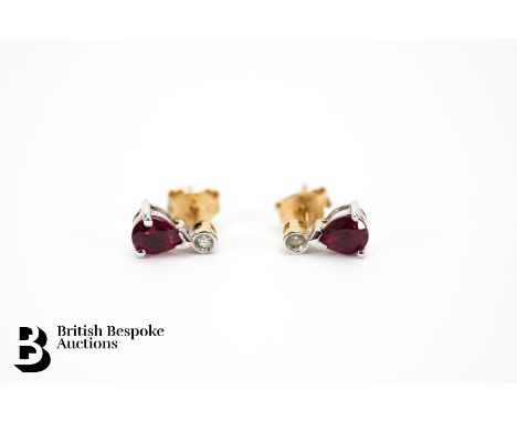 9ct yellow gold diamond and ruby earrings. The tear drop rubies measure 5 x 4mm with two 1pt dias, each earring measures 8mm,