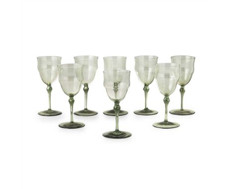 THOMAS GRAHAM JACKSON (1835-1924) FOR JAMES POWELL &amp; SONS SET OF EIGHT OLIVE GREEN DRINKING GLASSES, each of swollen trum