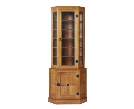 ROBERT 'MOUSEMAN' THOMPSON (1876-1955) OAK CORNER CABINET, CIRCA 1950with single leaded and glazed door, enclosing glass shel