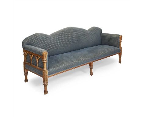 ENGLISH SCHOOL GOTHIC REVIVAL GILDED OAK SETTEE, CIRCA 1870 with upholstered back and seat, the frame carved with lancet arch