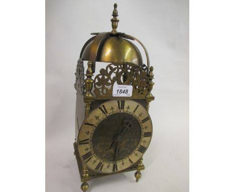 20th Century brass cased lantern clock having silvered chapter ring,  Roman numerals and floral engraved dial with single tra