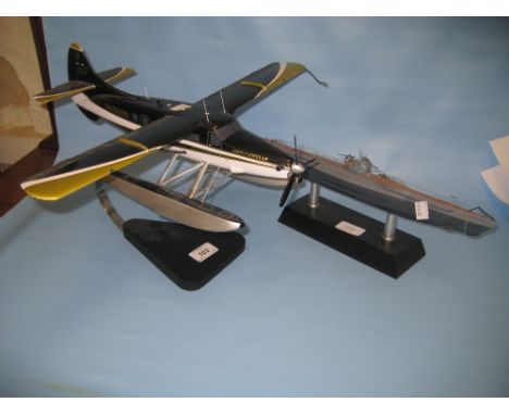 Scale model of a sea plane, another model of a submarine and a small wooden pond yacht