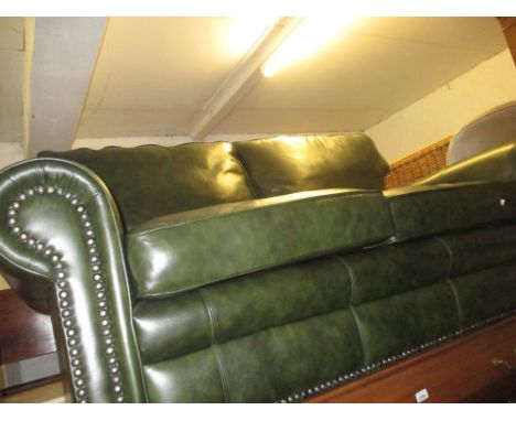 20th Century Chesterfield type button back two seat sofa with green leather upholstery and loose cushions