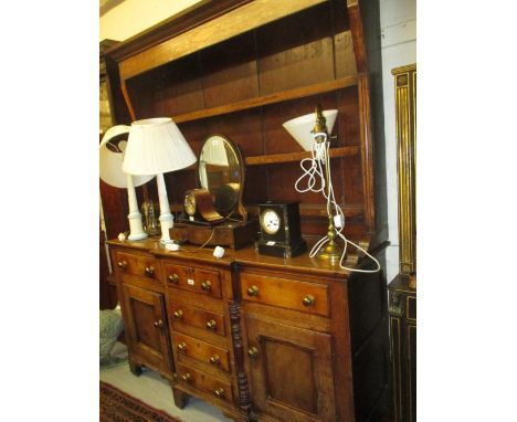 Early 19th Century oak and fruitwood Anglesey dresser, the boarded shelf back above a breakfront base with six drawers and tw