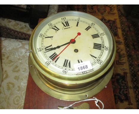 English circular brass cased ship's bulkhead clock, the enamel dial with Arabic and Roman numerals