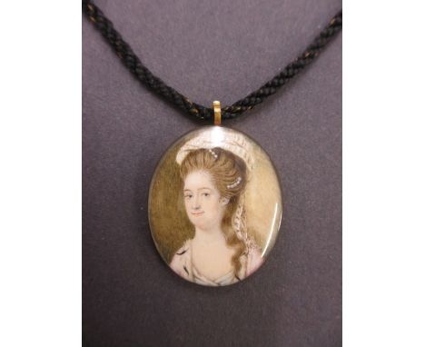 Edward Vaughan, oval watercolour miniature, portrait of a lady, signed with initials E.V., 5cms x 4cms, mounted on a hair wor