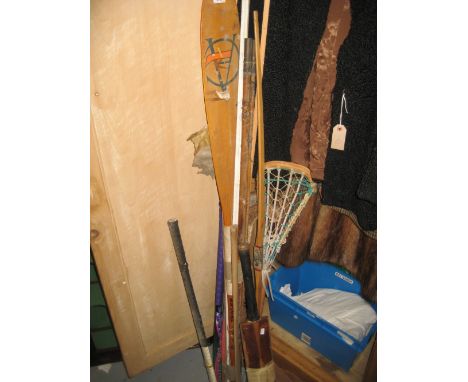 Miscellaneous sporting related items including cricket bat, hockey sticks, fishing rods, archery bow etc., together with a ba