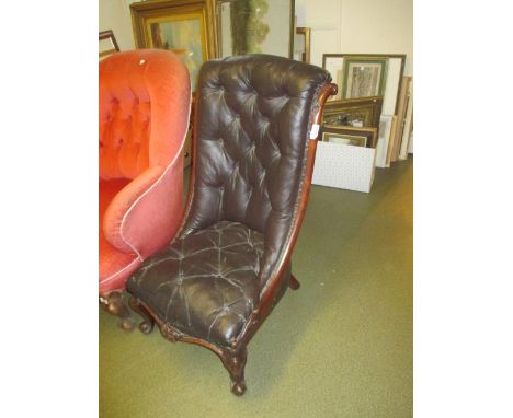 Victorian button upholstered low seat nursing chair with a carved mahogany frame