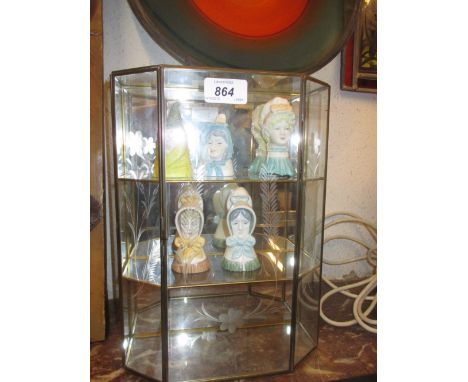 Group of five various Royal Worcester candle snuffers housed in a brass and glazed display cabinet