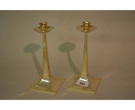 Pair of Edwardian Arts and Crafts silver candlesticks by Mappin and Webb with simulated riveted tapering bases, Sheffield 190