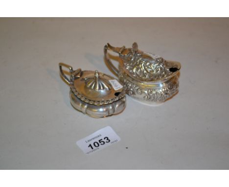Late Victorian silver mustard with embossed decoration, Birmingham 1898, together with another, Sheffield 1909