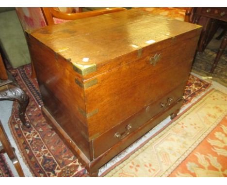 Good quality 19th Century teak and brass bound trunk with hinged cover above two drawers on low supports