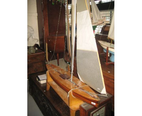 Large mid 20th Century sloop rigged pond yacht with racing sails and wind vane steering, the plank effect deck above a natura
