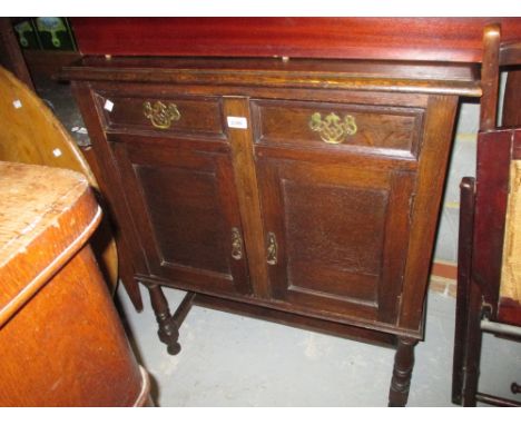 Small oak sideboard with low shelf back above two drawers and two cupboard doors