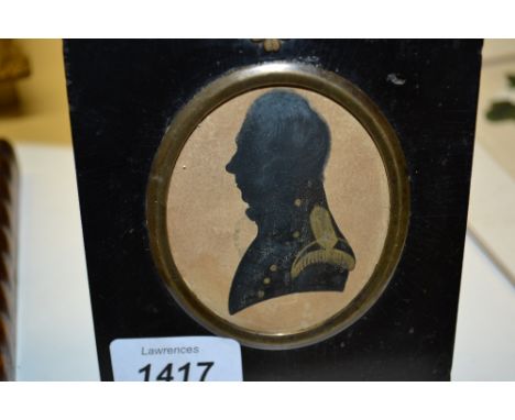 Near pair of early 19th Century silhouette paintings highlighted with gilt, portrait of a military gentleman and a young lady