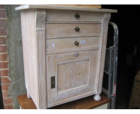 Continental pine lime waxed washstand having hinged cover above a single drawer and single panel door on turned supports