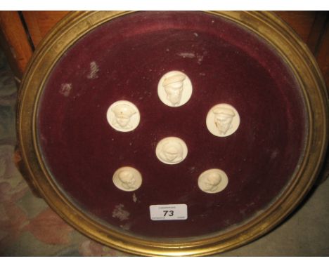 Circular gilt framed group of six carved miniature portrait plaques