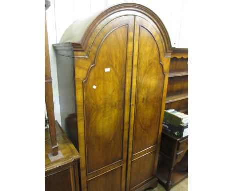 Early 20th Century walnut dome topped wardrobe in Queen Anne style with two panel doors, raised on bracket supports
