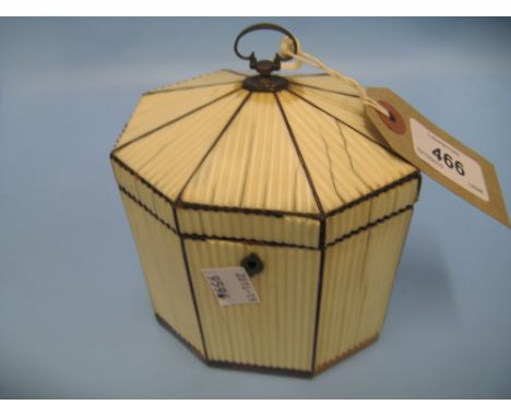 George III ivory and tortoiseshell tea caddy of irregular octagonal form, the hinged lid with original loop handle enclosing 