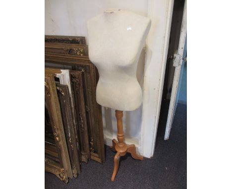 Dressmakers dummy, a wrought iron coat stand and a gentlemans valet stand