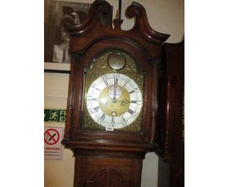 George III oak longcase clock, the broken arch hood with swan neck pediment and flanking pilasters above an arched panel door