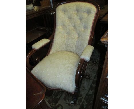 Early Victorian mahogany and button upholstered open arm library chair, the scroll arms above an overstuffed seat and turned 