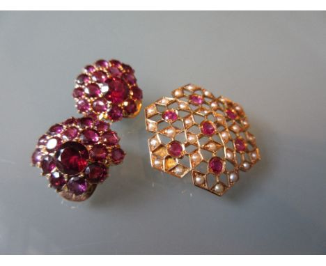 Unmarked yellow metal brooch of pierced design set with garnets and split pearls together with a pair of unmarked ear clips s