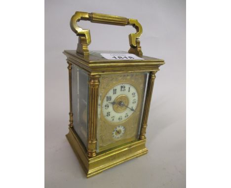 Good quality late 19th or early 20th Century brass carriage clock with fluted corner pilasters, the engraved brass dial with 