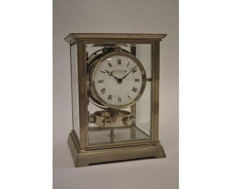 Rare 1930's Atmos clock by J.L. Reutter, the silvered brass case enclosing an enamel dial with Roman numerals, the dial inscr