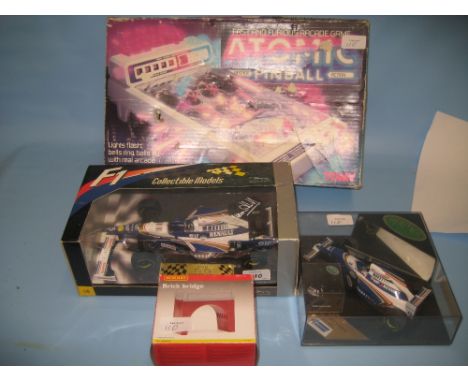 Two boxed scale model racing cars together with a boxed Hornby bridge and a boxed pinball machine