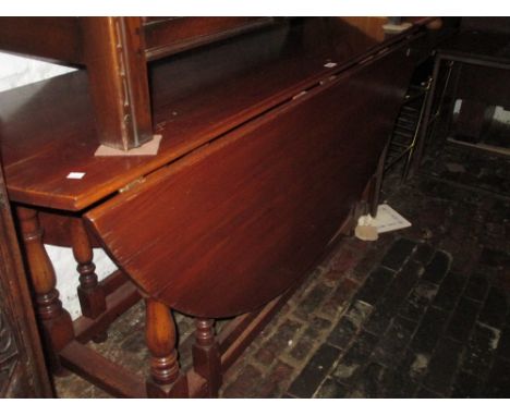 Large reproduction oak gate leg dining table on turned supports with stretchers, together with a set of similar dining chairs