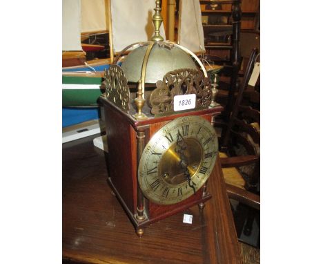 Brass and oak lantern clock with a silvered dial, Roman and Arabic numerals and a two train movement striking on a bell