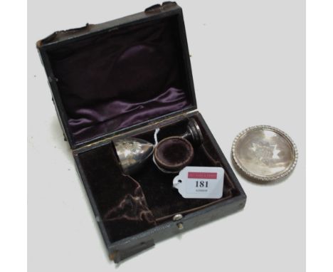 A late Victorian leather cased silver travelling communion set comprising; chalice and paten but lacking flask