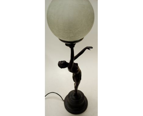 An art deco style bronzed composition table lamp as a female nude with frosted glass globe shade