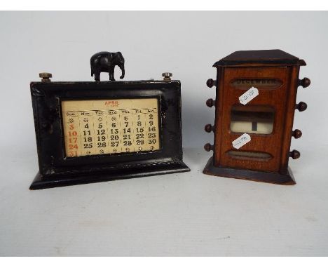 An Edwardian perpetual desk calendar and one other, largest approximately 17 cm (h). [2]Condition Report: Mahogany cased exam